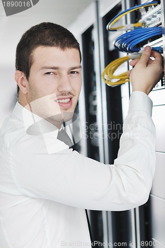 Image of young it engeneer in datacenter server room