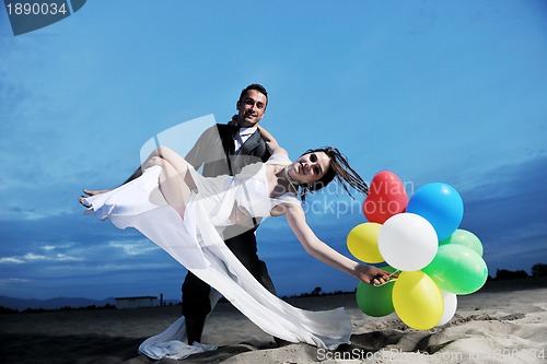 Image of romantic beach wedding at sunset
