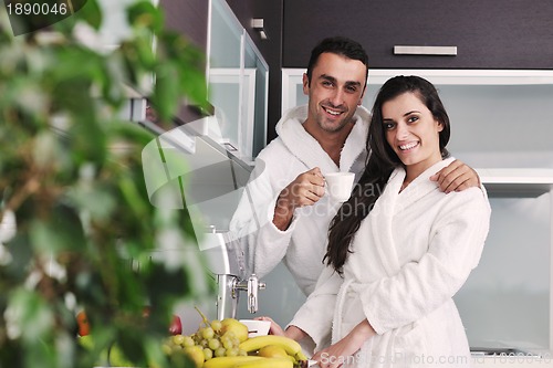 Image of Young love couple taking fresh morning cup of coffee