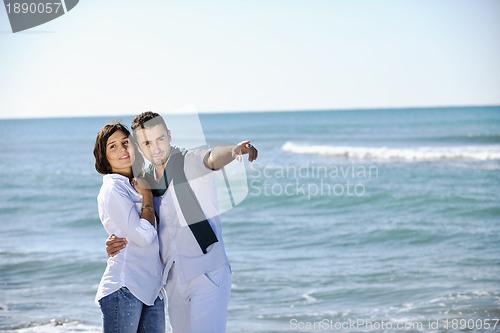Image of happy young couple have fun at beautiful beach