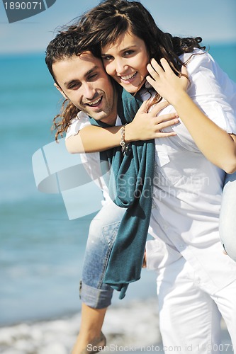 Image of happy young couple have fun at beautiful beach