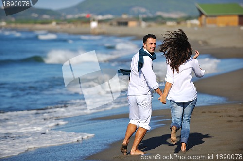 Image of happy young couple have fun at beautiful beach