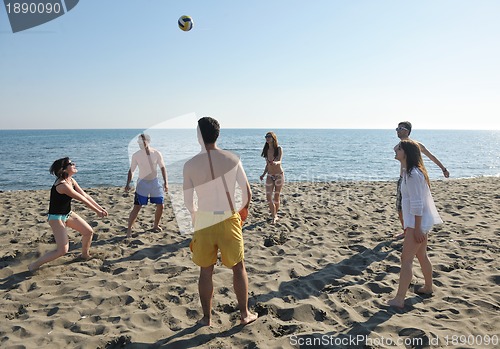 Image of young people group have fun and play beach volleyball