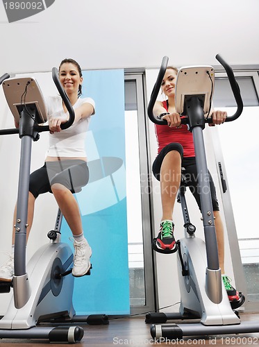 Image of womanworkout  in fitness club on running track machine 