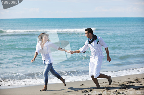 Image of happy young couple have fun at beautiful beach