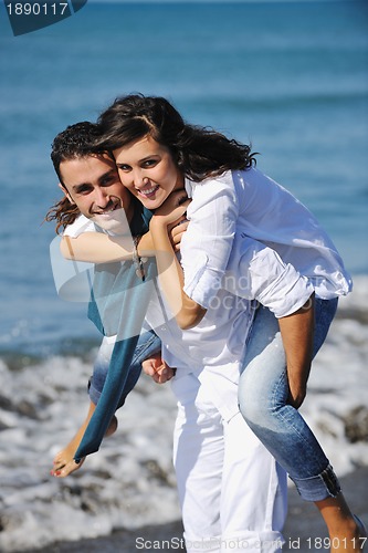 Image of happy young couple have fun at beautiful beach