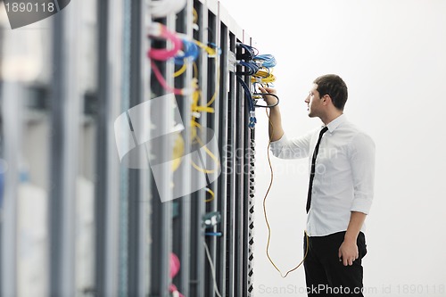 Image of young it engeneer in datacenter server room