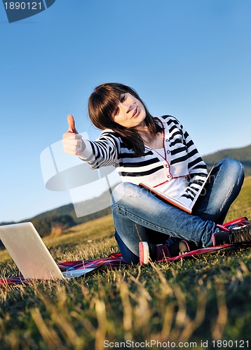 Image of young teen girl work on laptop outdoor