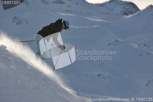 Image of woman skiing on fresh snow at winter season 