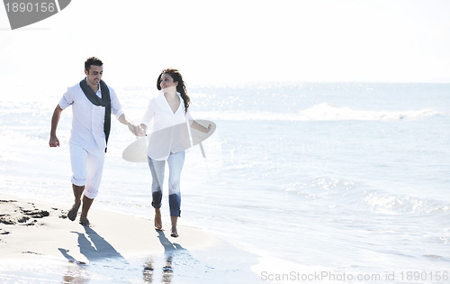 Image of happy young couple have fun at beautiful beach