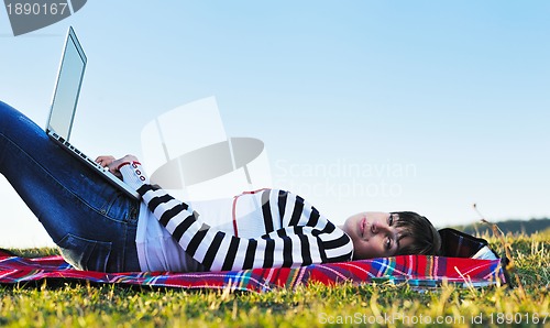 Image of young teen girl work on laptop outdoor