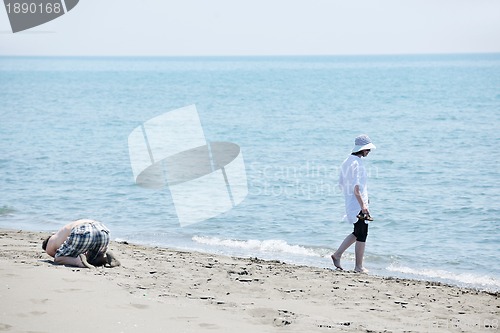 Image of happy young couple have fun on beach