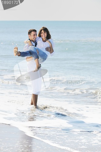 Image of happy young couple have fun at beautiful beach