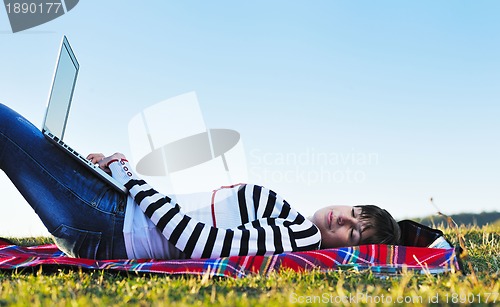 Image of young teen girl work on laptop outdoor