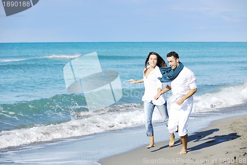 Image of happy young couple have fun at beautiful beach