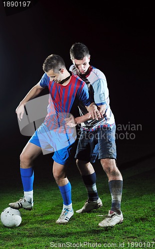 Image of football players in competition for the ball