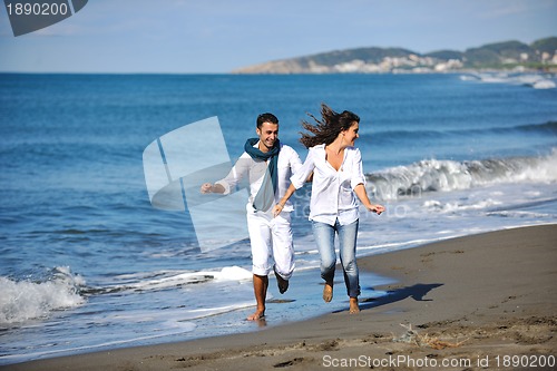 Image of happy young couple have fun at beautiful beach