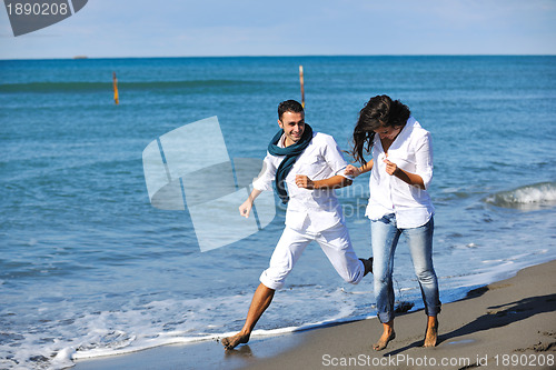 Image of happy young couple have fun at beautiful beach