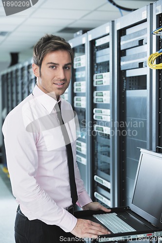 Image of young it engeneer in datacenter server room