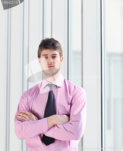 Image of young business man alone in conference room