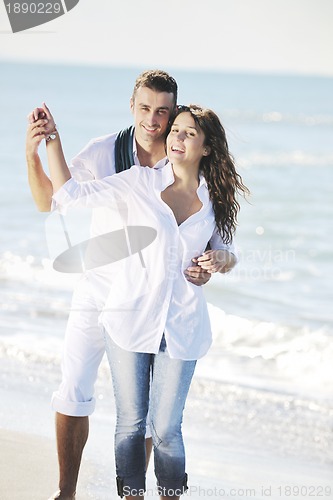 Image of happy young couple have fun at beautiful beach