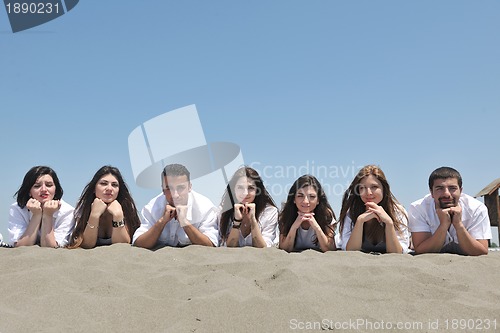 Image of Group of happy young people in have fun at beach
