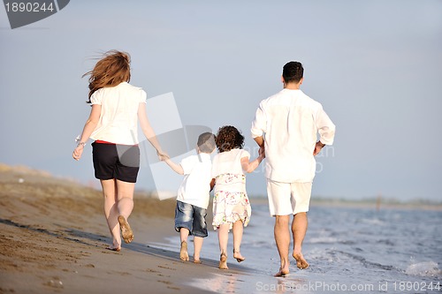 Image of happy young family have fun on beach