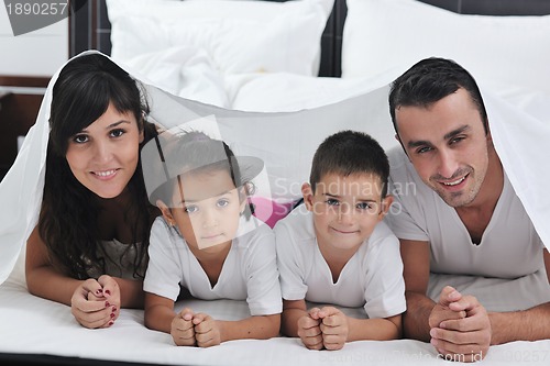 Image of happy young Family in their bedroom