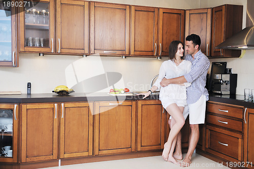 Image of happy young couple have fun in modern kitchen