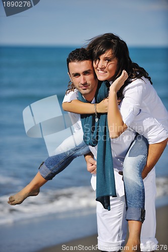 Image of happy young couple have fun at beautiful beach