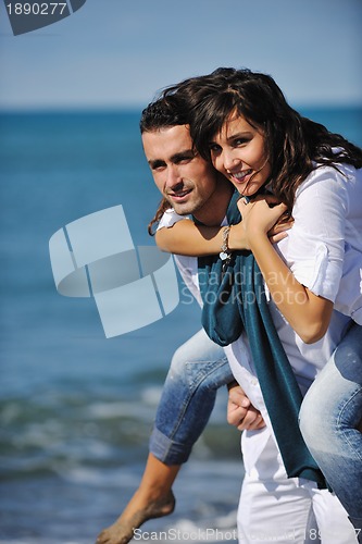 Image of happy young couple have fun at beautiful beach