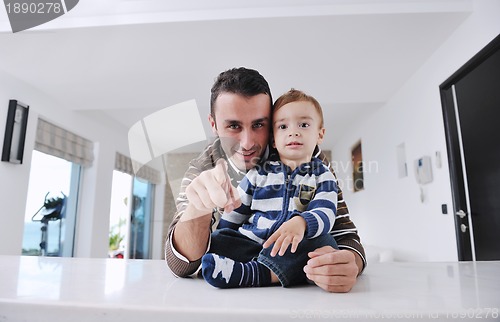 Image of happy father and son together at home