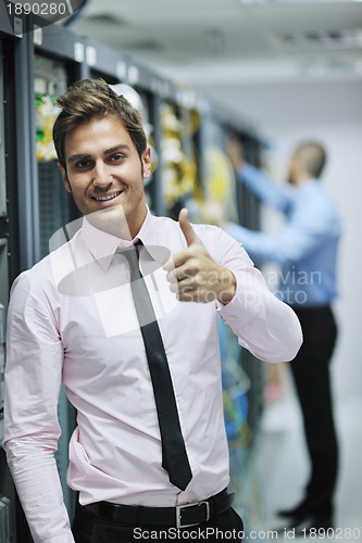 Image of it engineers in network server room