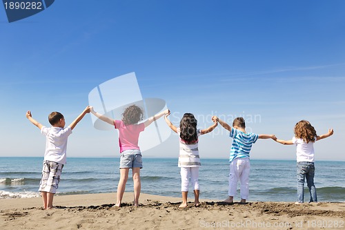 Image of happy child group playing  on beach