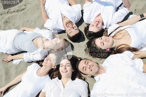 Image of Group of happy young people in have fun at beach