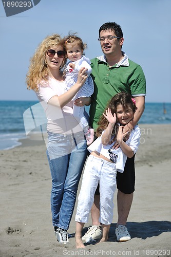 Image of happy young family have fun on beach