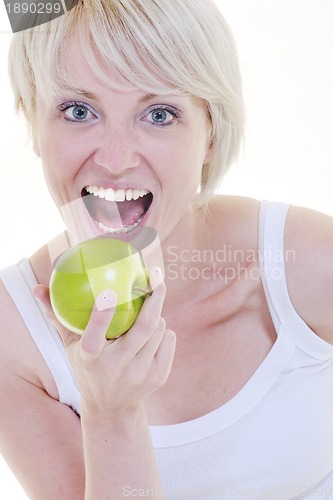Image of happy  young  woman eat green apple isolated  on white