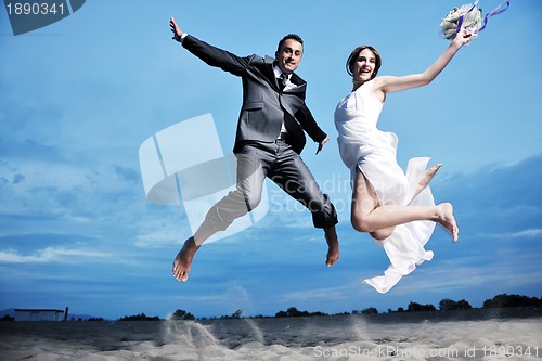 Image of romantic beach wedding at sunset