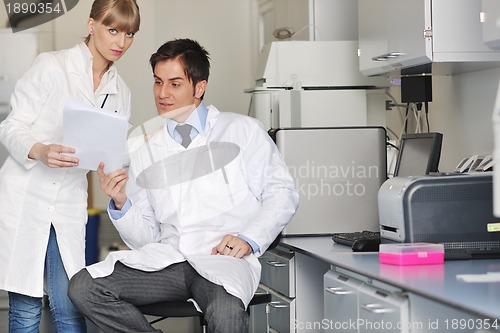 Image of science people in bright lab