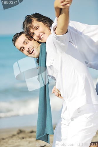 Image of happy young couple have fun at beautiful beach