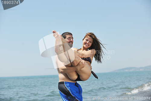 Image of happy young couple have fun on beach