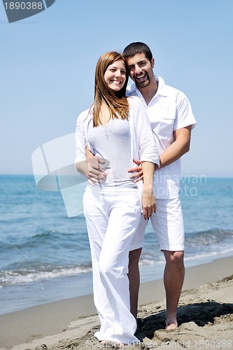 Image of happy young couple have fun on beach