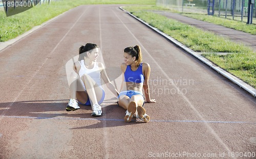 Image of happy young woman on athletic race track