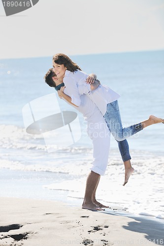 Image of happy young couple have fun at beautiful beach
