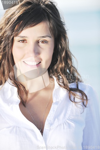 Image of happy young woman on beach
