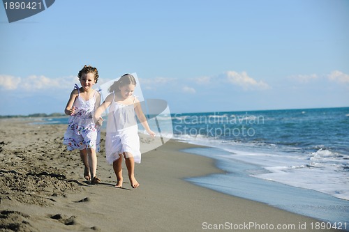 Image of cute little girls running on beach