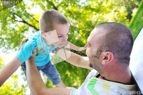 Image of happy father and son have fun at park