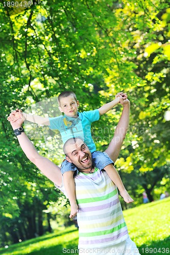 Image of happy father and son have fun at park