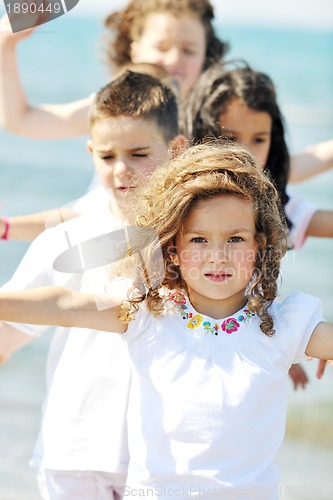 Image of happy child group playing  on beach