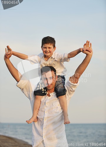Image of happy young family have fun on beach